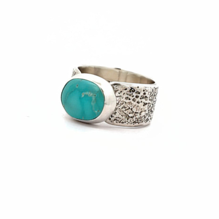 Silver ring with turquoise stone on a white background